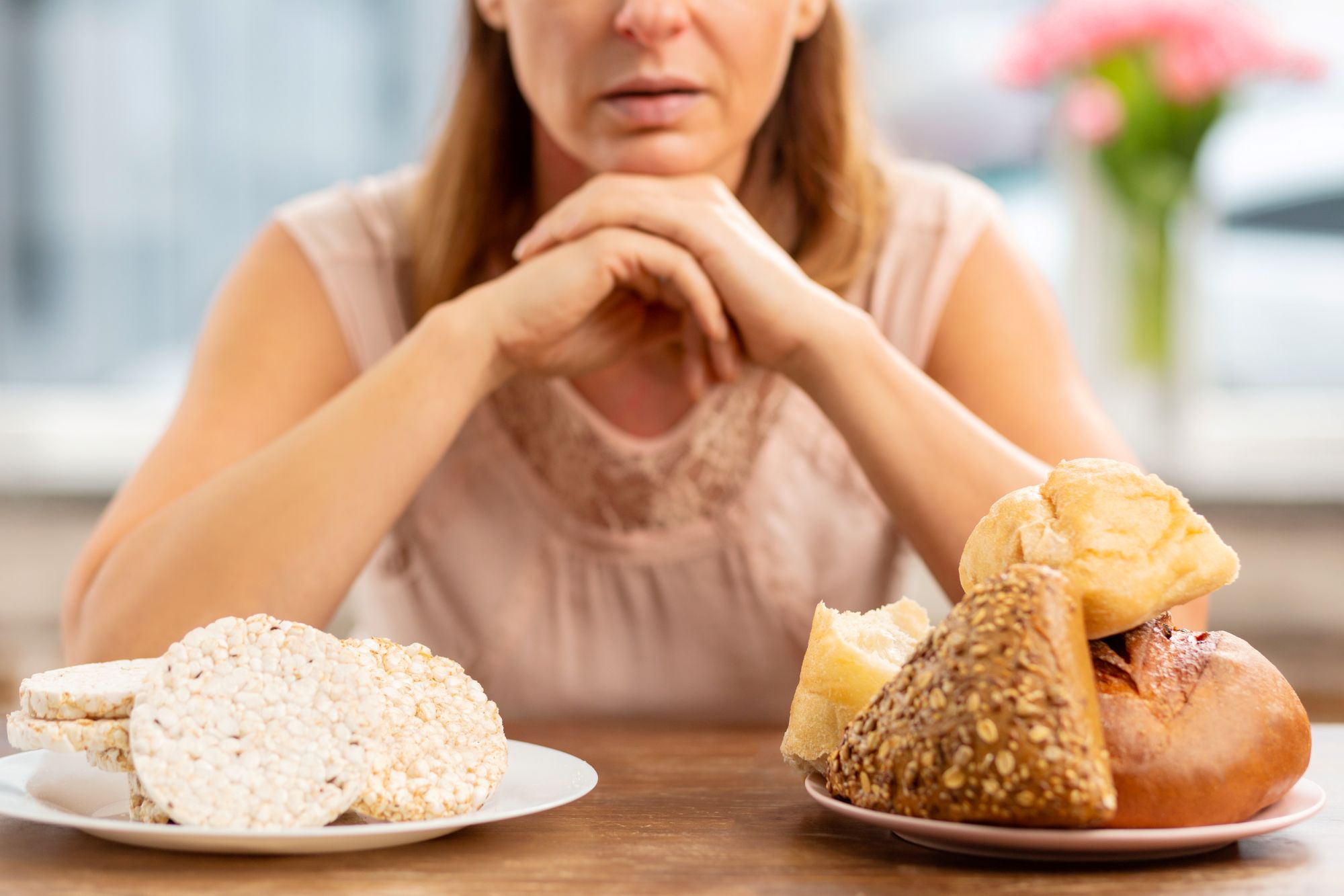 Mujer eligiendo entre pan y comida sin gluten 
