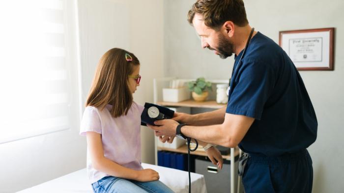 Prevalence of pediatric hypertension nearly doubled in the last 20 years girl at medical appointment